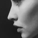 grayscale photo of womans face