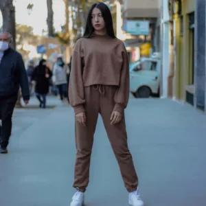 woman in brown long sleeve shirt and brown pants standing on white floor